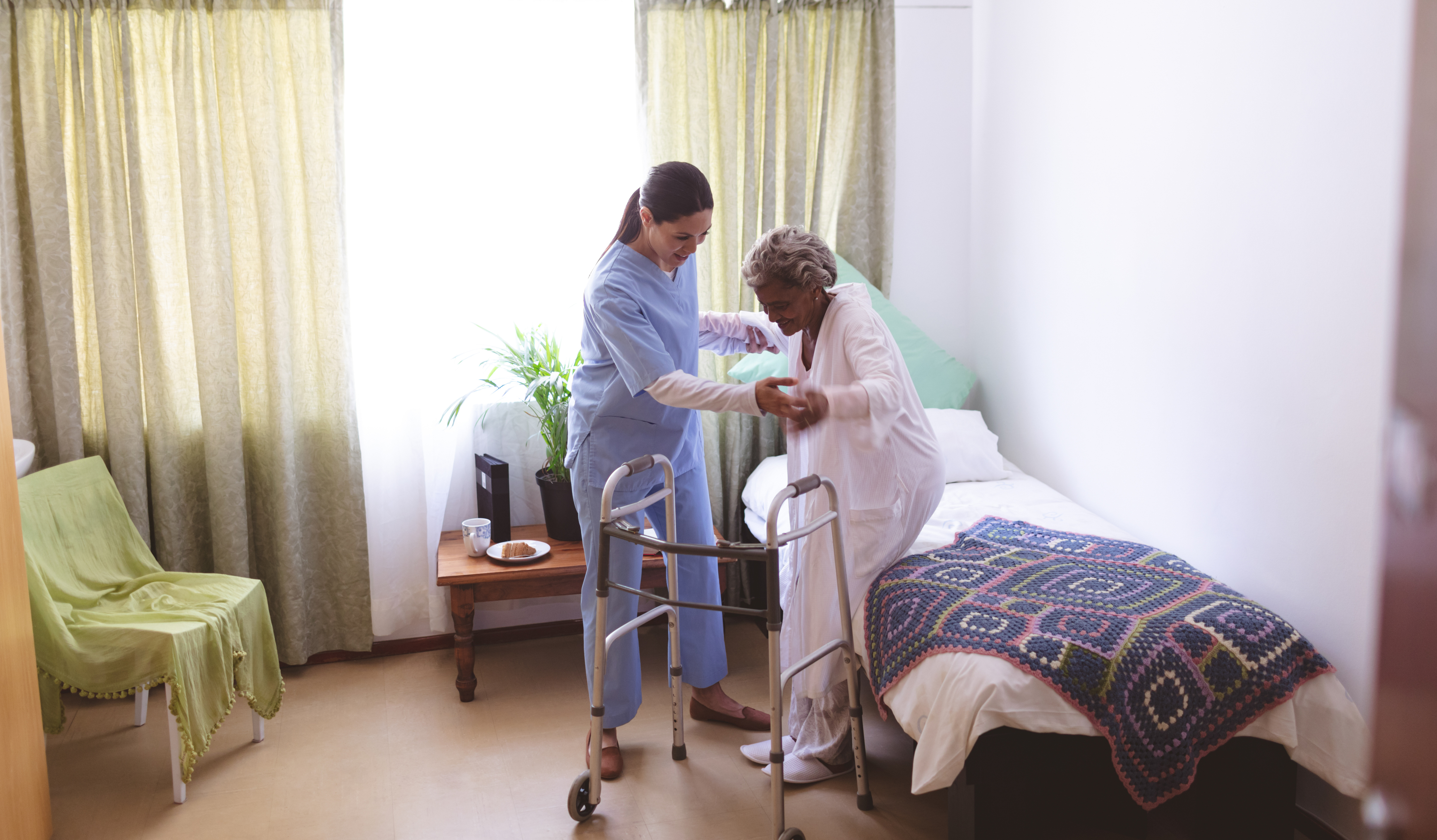 Photo representing a nurse assisting a client in order to prevent injury