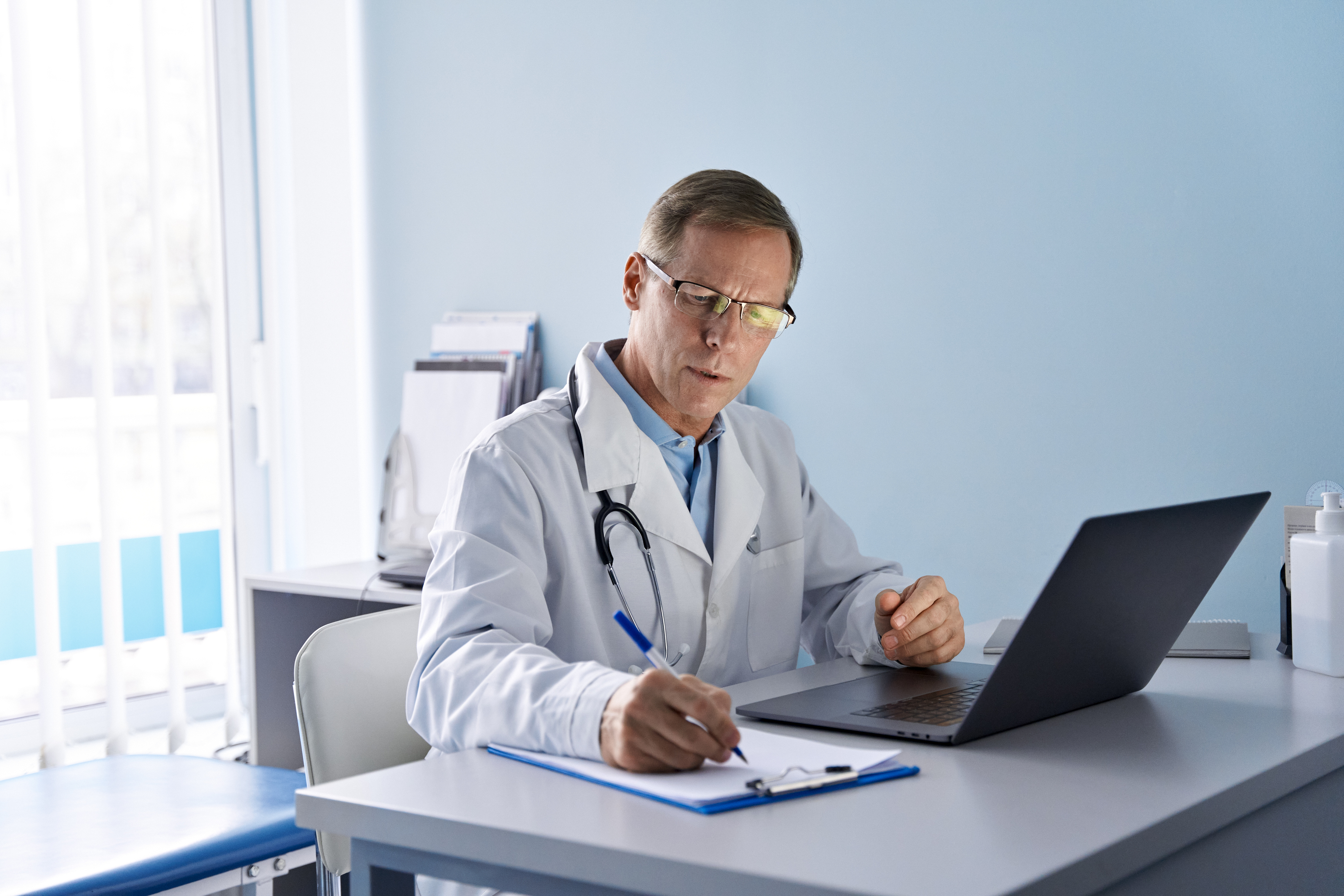 Photo representing a nurse using proper body mechanics while assisting a client
